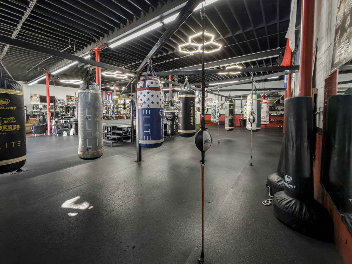 Heavy bags and double-end bags across the boxing training area