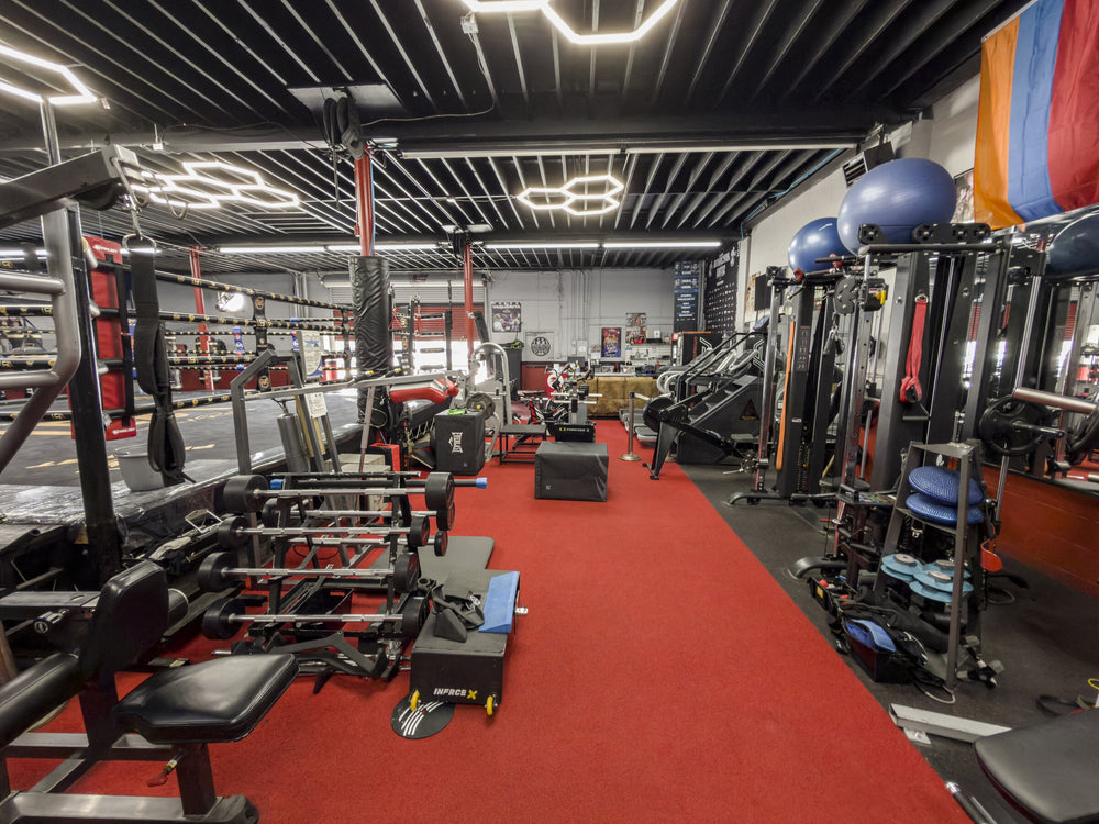 Strength equipment along the red aisle beside the boxing ring